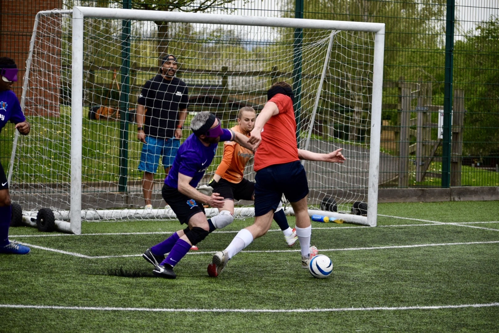 Coleman (for RNC) and Turnham (for Merseyside) in a tussle in front of the Merseyside keeper (Christopher)